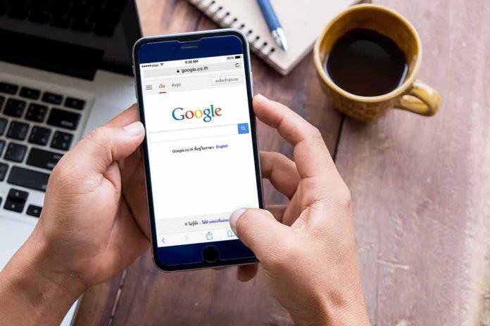 Hands using smartphone with search engine on screen