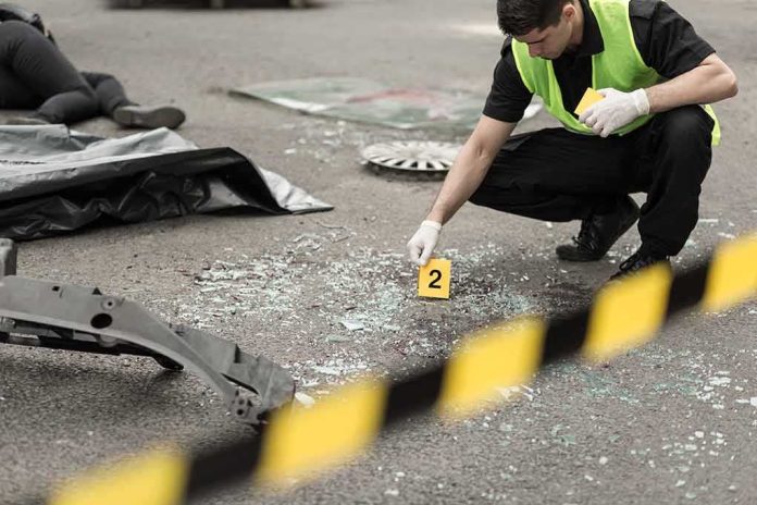 Forensic investigator marking evidence at crash scene