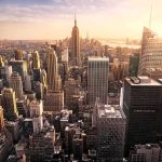 Skyline of a dense city with tall skyscrapers at sunset
