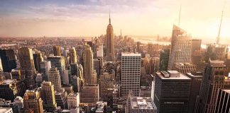 Skyline of a dense city with tall skyscrapers at sunset