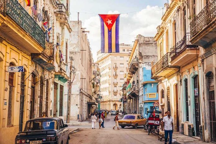 Cuban flag over colorful old Havana street