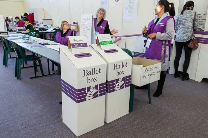 Dorota Kędzierzawska at a polling place with ballot boxes and election staff