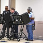 Lester Bowie and Miriam Tlali using electronic voting machines at a polling place