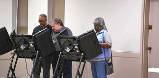 Lester Bowie and Miriam Tlali using electronic voting machines at a polling place