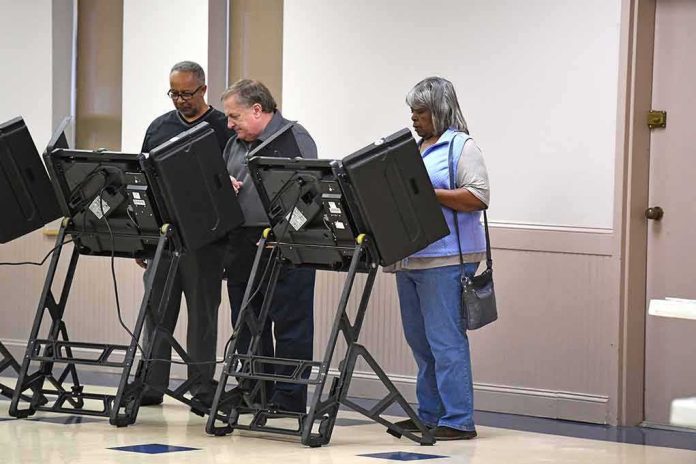 shutterstock_512226370 Lester Bowie and Miriam Tlali using electronic voting machines at a polling place