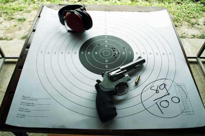 Revolver and ear protection on paper shooting target