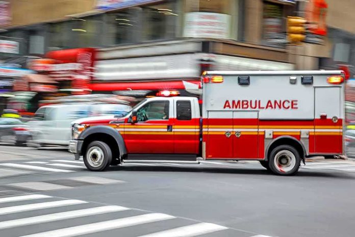 shutterstock_690581653 Ambulance speeding through a city intersection with lights on