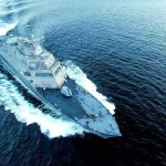 Naval warship cutting through open sea