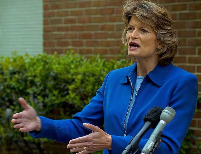 Lisa Murkowski speaking at an outdoor press conference with microphones in front