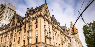 Historic stone apartment building on a busy city corner