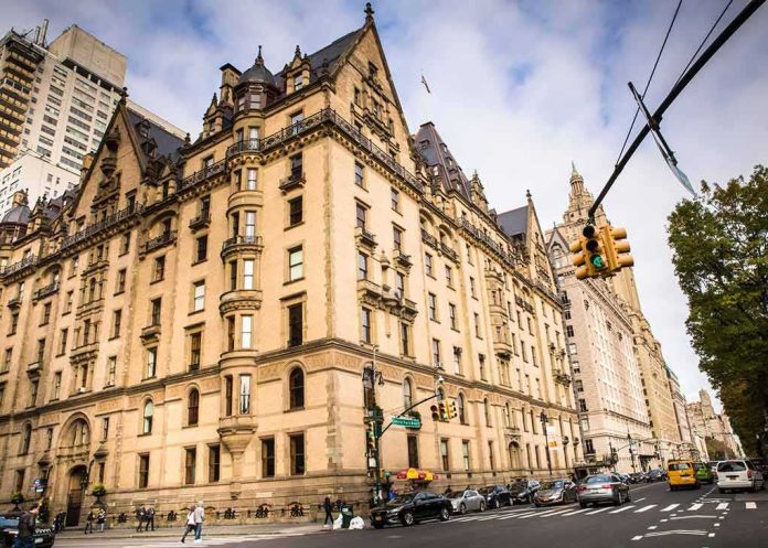 Historic stone apartment building on a busy city corner