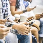 Group of people sitting and using smartphones