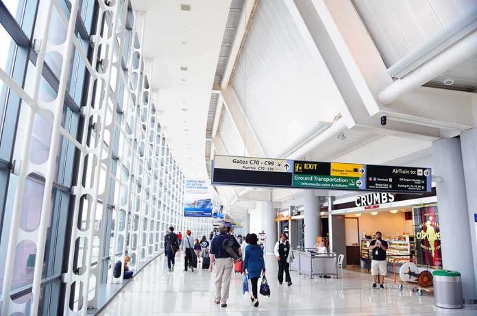 Airport terminal hallway with travelers and signage