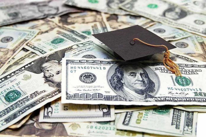 Graduation cap on a pile of US dollar bills
