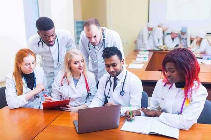 Group of medical students collaborating around a laptop