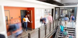 Unions Panic As NY Backs Trump Scholarships Students walking through a modern school hallway and stairwell