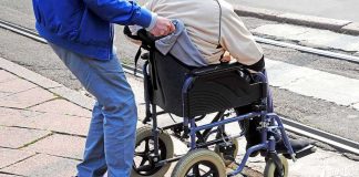 Breaking Bad Tragedy Stuns Hollywood Caregiver pushing person in wheelchair over curb