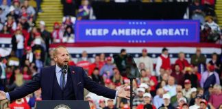 Boxing Legend Drops Surprise Trump Praise Crowd at a political rally with a speaker at a podium; Stephen Paea, Curtis Lofton, Walter Jones, John Sullivan, and Colin David Jones present
