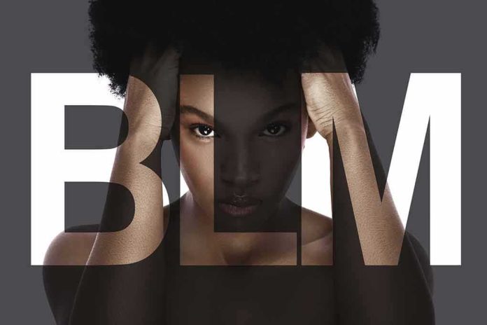 Woman with afro framed by large letters