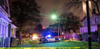 Chainsaw Murder Charges Shock Alabama Community Police car blocks residential street at night behind caution tape