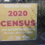 Yellow 2020 census sign on a sidewalk