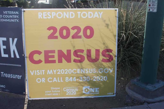 Yellow 2020 census sign on a sidewalk