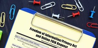 FOIA request form on a clipboard with office supplies