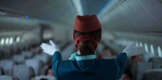 Actress Faces Assault Charges After Delta Flight Chaos Flight attendant giving safety demonstration in airplane aisle