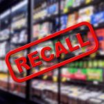 Recall sign over supermarket freezer aisle
