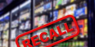Recall sign over supermarket freezer aisle