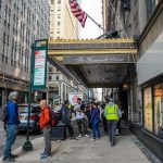 Jewish Man Targeted in Disturbing Street Attack Andreas Hestler and pedestrians outside The Roosevelt Hotel entrance on a city sidewalk