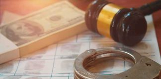 Handcuffs on fingerprint form with gavel and cash
