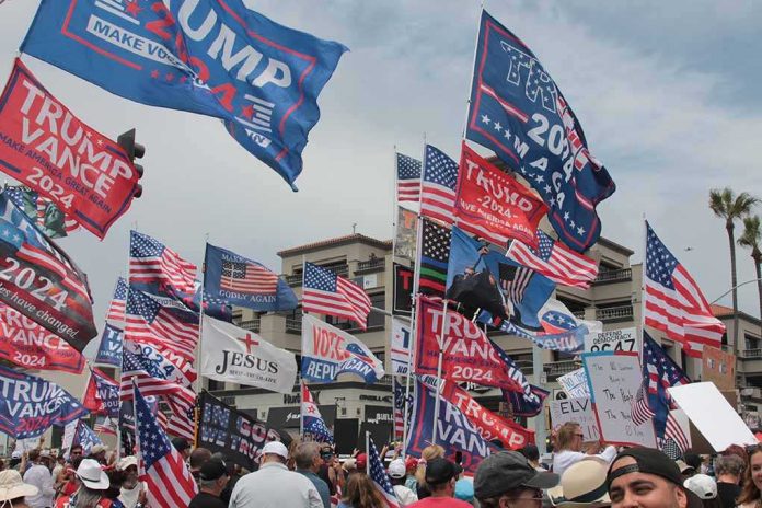 shutterstock_2641208321 Crowd at political rally with many American and campaign flags