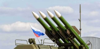 Russia Draws A Nuclear Red Line Surface-to-air missile launcher with green rockets and a raised Russian flag