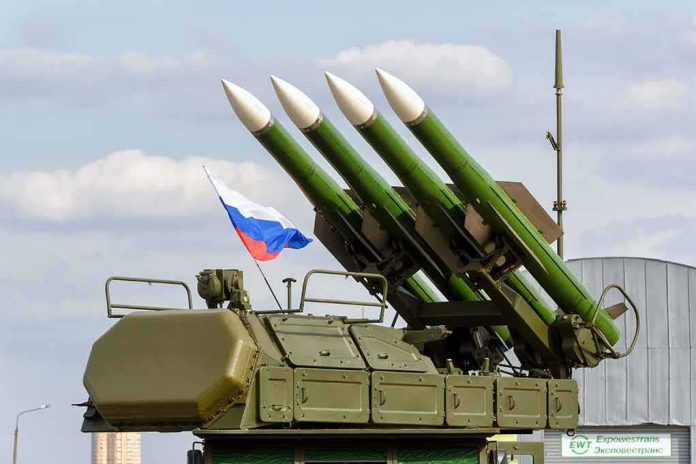 shutterstock_311011061 Surface-to-air missile launcher with green rockets and a raised Russian flag