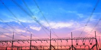 Electrical substation with power lines at sunset