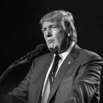 Eight-Foot Naked Trump Statue Goes On Display Donald Trump speaking at a microphone in a black-and-white photo
