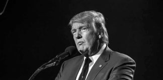 Eight-Foot Naked Trump Statue Goes On Display Donald Trump speaking at a microphone in a black-and-white photo