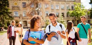 Fraternity Suspended After Sexual Assault Report College students walking on campus with books and backpacks