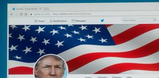 computer screen showing a social media profile with an american flag banner
